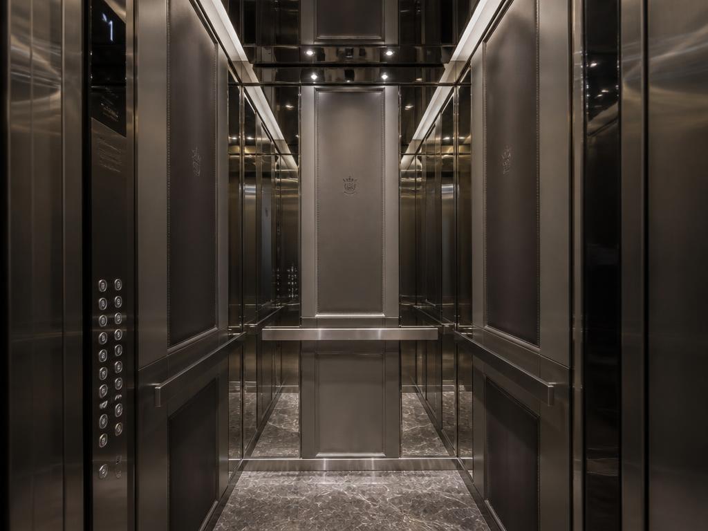 Mirrored steel and marble luxury hotel elevator cabin interior